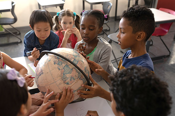 Students examining a globe