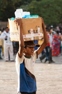 A boy selling water in India. Talk about water pressure!